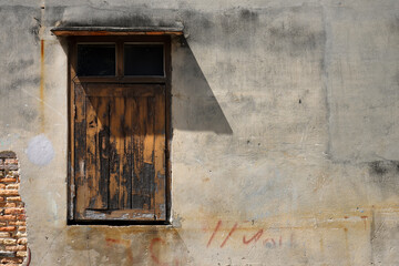 Old windows on the wall with shadow.