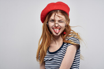 cheerful woman in a striped t-shirt red lips gesture with his hands summer