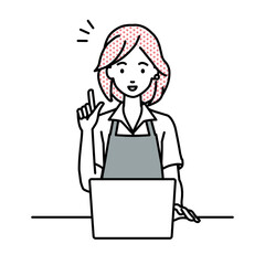 デスクで座ってPCを開いて何かひらめいたカフェ店員の女性