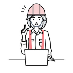 デスクで座ってPCを開いて何かひらめいた工事現場の女性