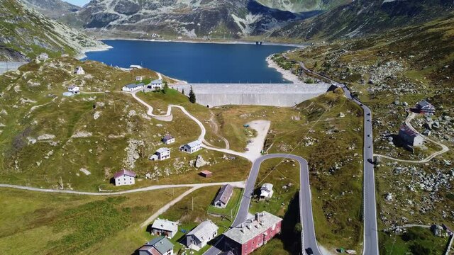 Montespluga dam and lake in Italy in the alps along the Splugen pass toward Switzerland. Shot with a tilt up motion