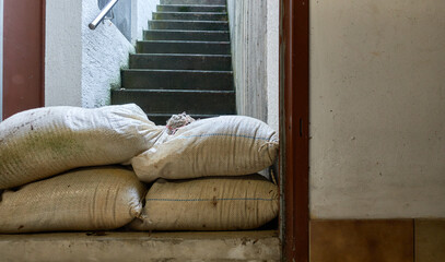 Protective measure against floods in basements. Barrier made of sandbags lies in the entrance area...