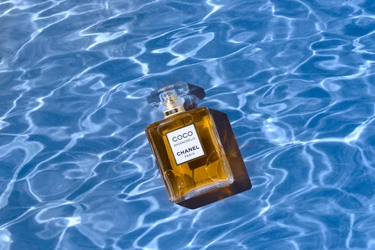 skulder Tilintetgøre Fuld A bottle of Chanel perfume on the background of the texture of water, with  a beautiful shadow with highlights. Coco Chanel women's perfume series.  2020-07-05 Samara. Stock Photo | Adobe Stock