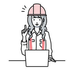 デスクで座ってPCを開いて何かひらめいた工事現場の女性