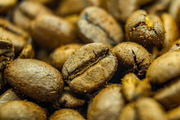 Brown grains of coffee beans. Close-up texture. Macro photo of food