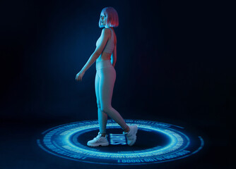 Woman in futuristic costume. Girl in glasses of virtual reality presses start button. Augmented reality game, future technology, AI concept. VR. Holographic interface to display data. Dark background.