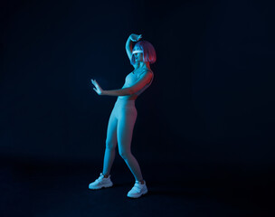 Woman in futuristic costume. Female in modern VR glasses interacting with network while having...