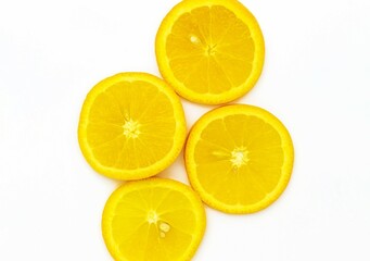 Top view of four juicy orange slices that lie on a white background