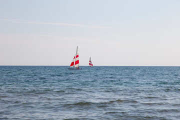Fototapeta premium Two Windsurfing yachts on the horizon