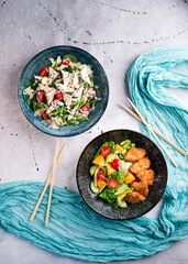 Fresh vegetable salads on table flat lay. Top view on kitchen table with two dishes Restaurant, menu, buffet concept