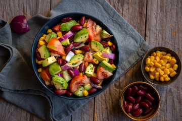 Avocado salad with other vegetables, tomatoes and corn. Healthy food