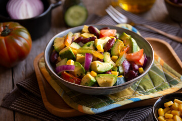 Avocado salad with other vegetables, tomatoes and corn. Healthy food