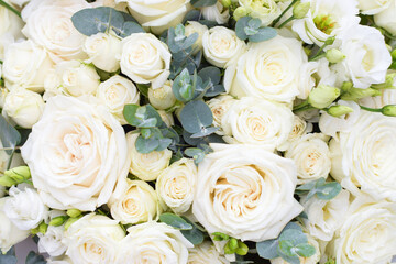 Fototapeta na wymiar Floral background of white roses, eucalyptus, bouquet