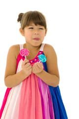 Portrait of cute preteen child having fun with lollipops