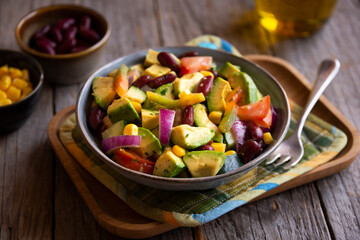 Avocado salad with other vegetables, tomatoes and corn. Healthy food