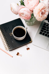 cup of coffee, pink flowers, perfume and macaroons on white background, top view 