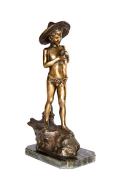Vintage bronze statuette depicting a boy in swimwear fishing on a rock isolated on white.