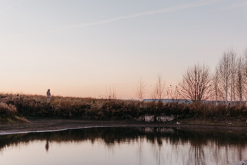 the girl admires nature and walks near the lake