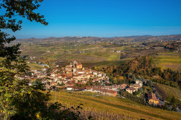 Fototapeta na wymiar Panorama on Barolo Village, Cuneo, Italy, among the autumn colored vineyards on the Langhe hills