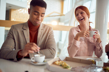 woman laughing at funny joke with diverse coworkers.friendly work team enjoying at lunch