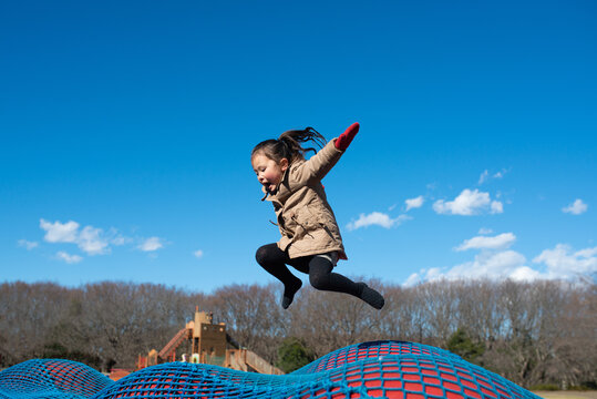 冬の公園で遊ぶ少女