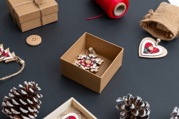 Making Christmas presents with Christmas decorations. A small box with a wooden flake, ready to pack. Close-up