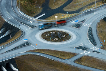 A high angle shot of a truck driving on a roundabout in Northern Finland. 