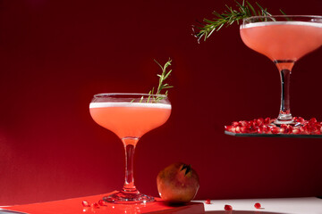Festive red cocktails. Pomegranate drinks with white egg and rosemary