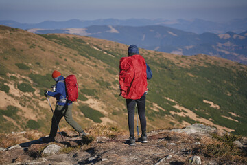 Tourists with backpacks at the top of the ridge. Ukrainian Carpathian mountains. Chornohora ridge.