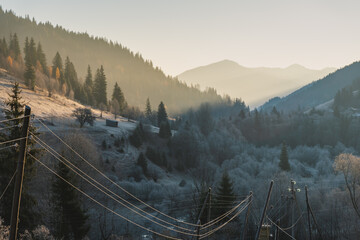 Dawn in the mountains. Frosty autumn morning. Ukrainian Carpathian mountains. The village of Bystrets.