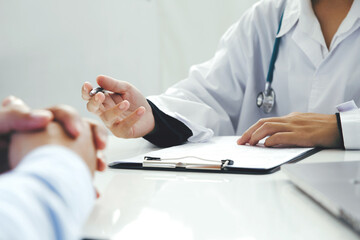 Doctor talking to patients are explaining the treatment of a patient's illness . Health and...