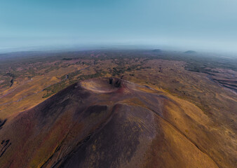Aerial view of mountain volcano valley with breakthrough hills and caldera