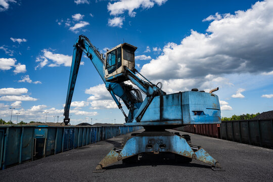 Loading of coal and coke into wagons at the reloading terminal with the use of excavators and buckets.