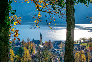 View of Schliersee lake through the trees during Autumn. Mountain lake Schliersee during Fall, german Alps, Bavaria, Germany
