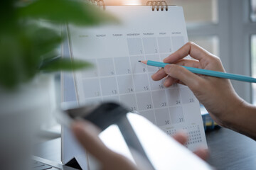 Event planner timetable agenda plan on schedule event. Business woman checking planner on mobile...