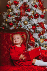 little girl in red dress with christmas gift