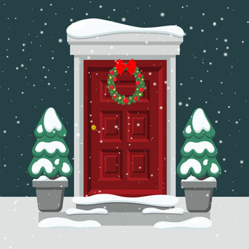 Door with a Christmas wreath. Christmas trees in the snow. Snow falls.