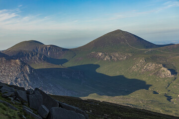 Long evening summertime shadows in the Mourne mountains seen from Slieve Binnian, Mournes area of outstanding natural beauty. County Down, Northern Ireland