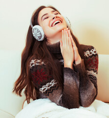 young pretty woman sitting in comfortable chair with coffee and blanket, winter season lifestyle...