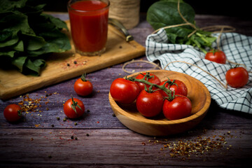 a bunch of fresh organic cherry tomatoes on a dark background.