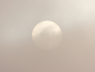 White sun in fog clouds.