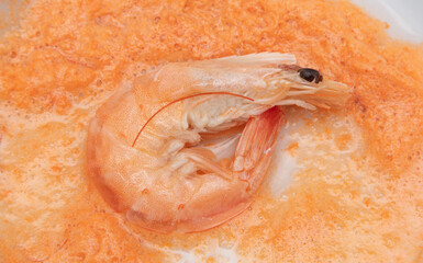 Red shrimps are boiled in a saucepan.