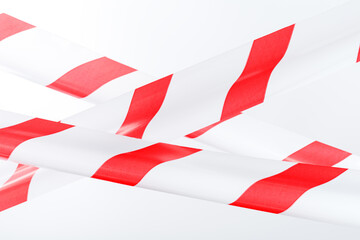 The tape is red and white for fencing danger on a white background.