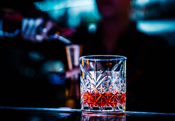woman hand bartender making negroni cocktail in bar