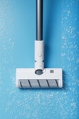 The turbo brush of the vacuum cleaner cleans white balls, top view on a blue background. The...