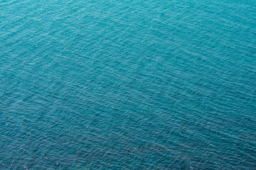 Fototapeta na wymiar Blue background of the sea with waves
