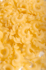 Close up of raw creste di gallo pasta background