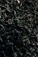 Heap of healthy organic black tea leaves, tea background