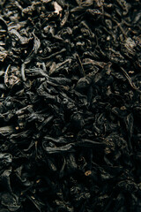 Heap of healthy organic black tea leaves, tea background