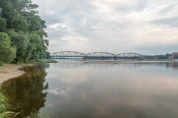 Jozef Pilsudski Bridge over Vistula River in the morning in Torun in Poland. - obrazy, fototapety, plakaty